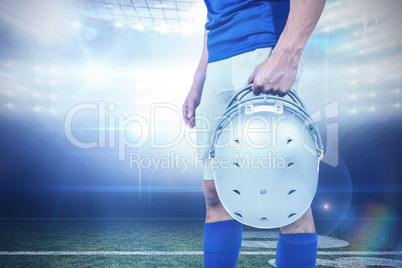 Composite image of sports player handing his helmet