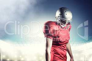 Composite image of american football player with ball looking do