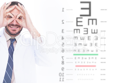 Composite image of smiling doctor forming eyeglasses with his ha