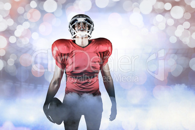 Composite image of american football player holding ball while l