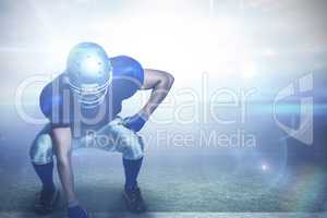 Composite image of american football player in uniform bending