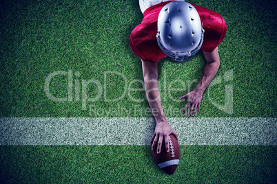 Composite image of american football player lying in front with