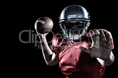 Composite image of portrait of sportsman defending while holding american football