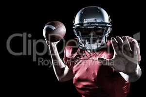 Composite image of portrait of sportsman defending while holding american football