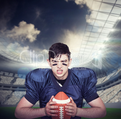 Composite image of enraged american football player holding a ba