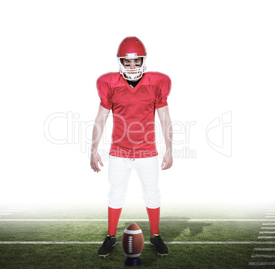 Composite image of serious american football player looking at c