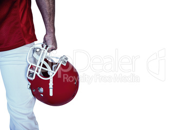 Midsection of rugby player holding helmet