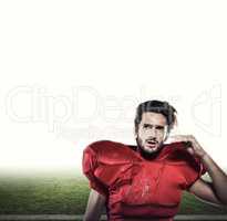 Composite image of wet american football player in red jersey lo