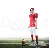 Composite image of a serious american football player taking his