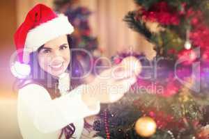 Festive brunette decorating a christmas tree