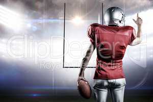 Composite image of rear view of american football player pointin