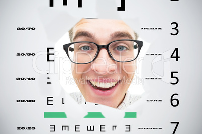 Composite image of geeky hipster smiling through hole