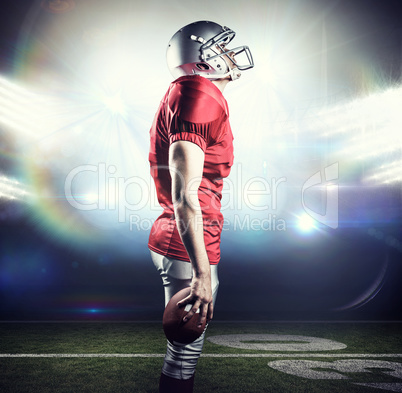 Composite image of american football player looking up while sta