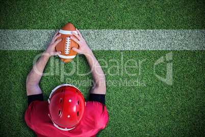 Composite image of american football player reaching football