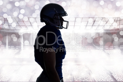 Composite image of side view of silhouette american football pla