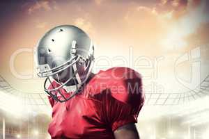 Composite image of american football player looking down