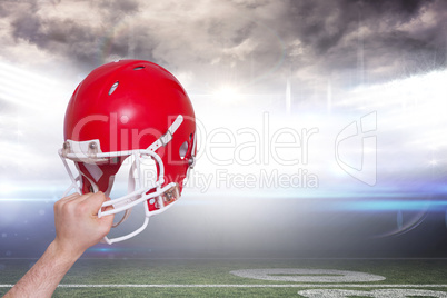 Composite image of american football player handing his helmet
