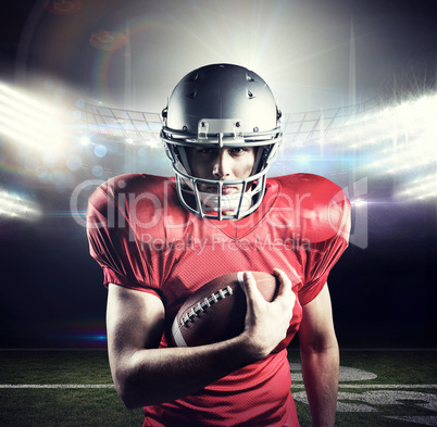 Composite image of portrait of confident sportsman holding ameri