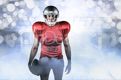 Composite image of portrait of american football player holding