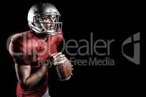 Composite image of aggressive american football player holding ball