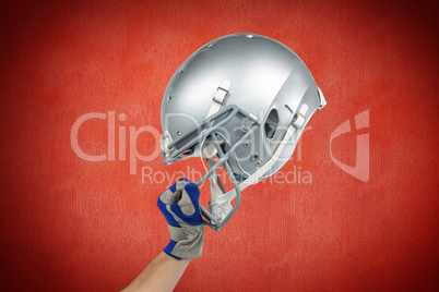 Composite image of american football player handing his helmet