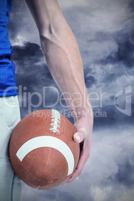 Composite image of midsection of sports player holding ball