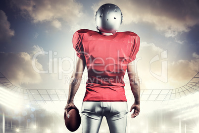 Composite image of rear view of american football player with ba