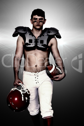 Composite image of american football player walking with a ball