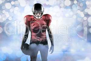 Composite image of american football player standing with ball