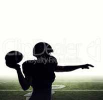 Composite image of silhouette american football player throwing