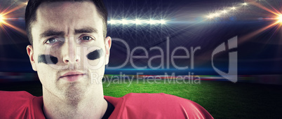 Composite image of smiling american football player looking at c