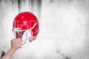 Composite image of american football player handing his helmet