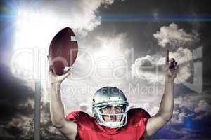 Composite image of american football player with arms raised hol