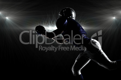 Composite image of silhouette american football player catching