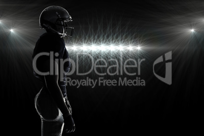 Composite image of side view of silhouette american football pla