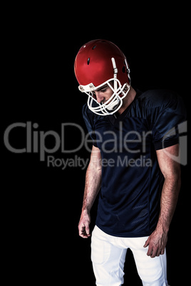 Composite image of rugby player looking down