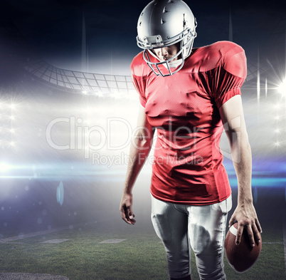 Composite image of american football player looking down while s