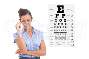 Composite image of businesswoman adjusting her glasses