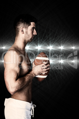 Composite image of side view of a shirtless rugby player holding