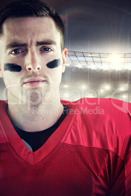 Composite image of american football player holding helmet