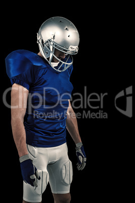 Composite image of american football player looking down