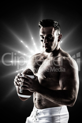 Composite image of shirtless american football player with ball