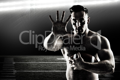 Composite image of shirtless american football player with ball