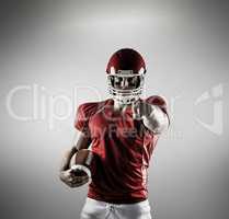 Composite image of american football player pointing at camera