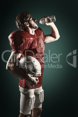 Composite image of thirsty american football player in red jerse