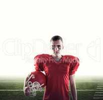 Composite image of a serious american football player looking at