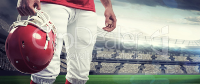 Composite image of an american football player taking his helmet