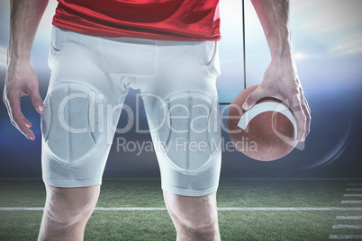 Composite image of sports player holding ball