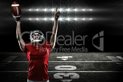 Composite image of american football player with holding ball ar