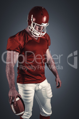 Composite image of american football player with ball